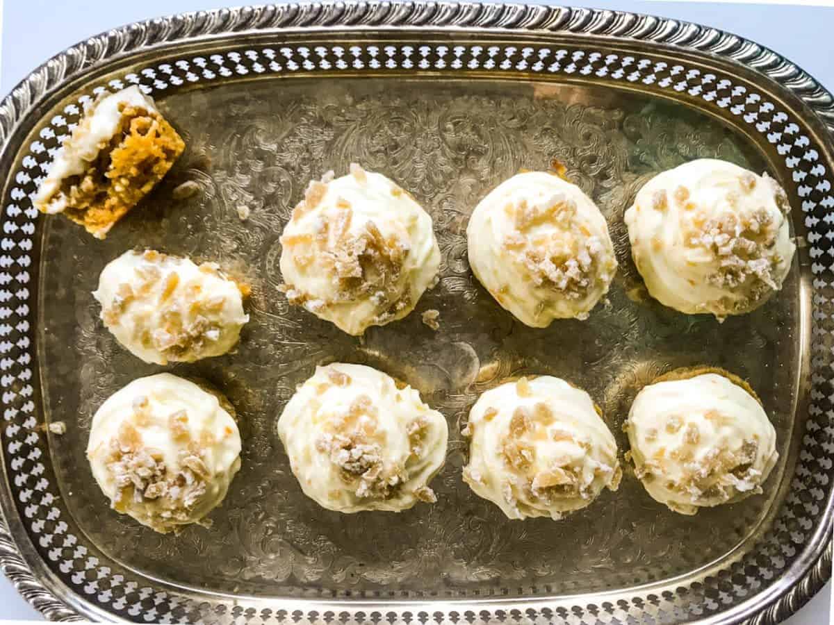 8 orange ginger carrot cupcakes on a silver tray