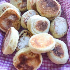 Overnight english muffins on a pink and white checkered cloth