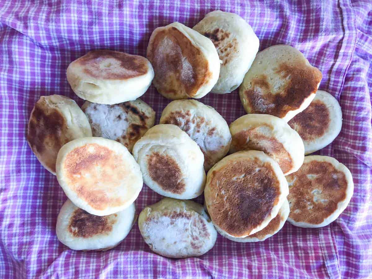 Overnight english muffins on a pink and white checkered cloth