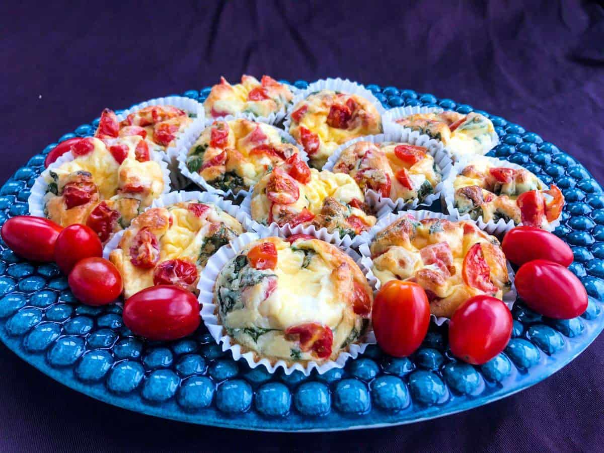 Healthy italian breakfast egg muffins on a blue plate on a purple surface