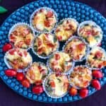 Healthy italian breakfast egg muffins on a muffin tray on a purple surface