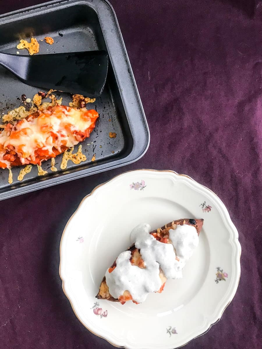 Buffalo bacon loaded sweet potato skins with blue cheese dressing on a purple surface