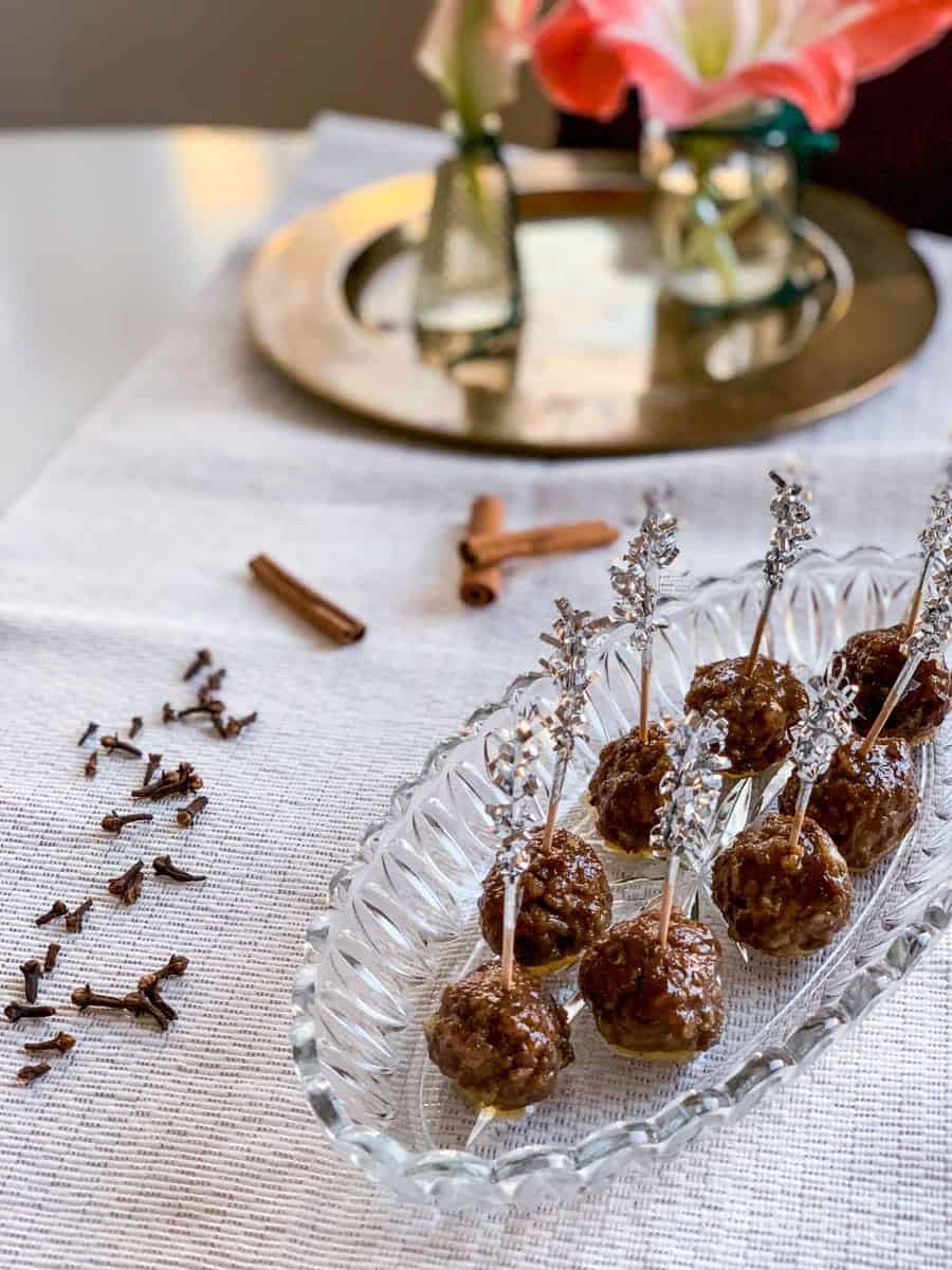 honey balsamic glazed gingerbread spice meatballs with tooth picks on a glass platter