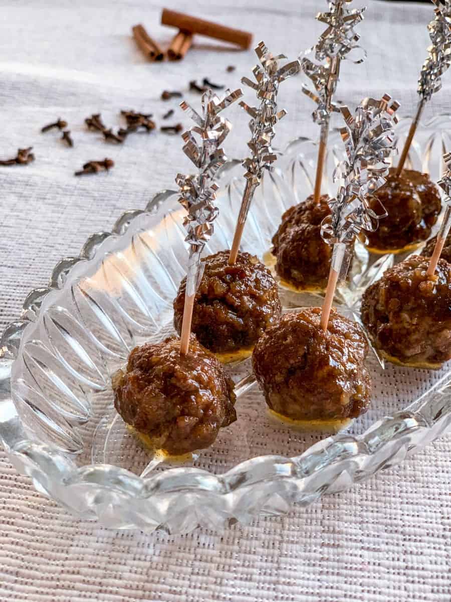 honey balsamic glazed gingerbread spice meatballs with tooth picks on a glass platter