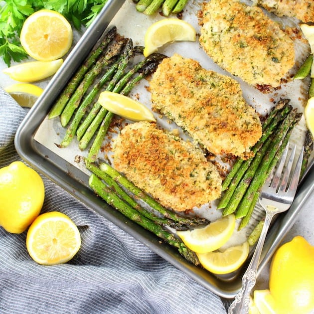 parmesan pork chops and asparagus on a sheet pan