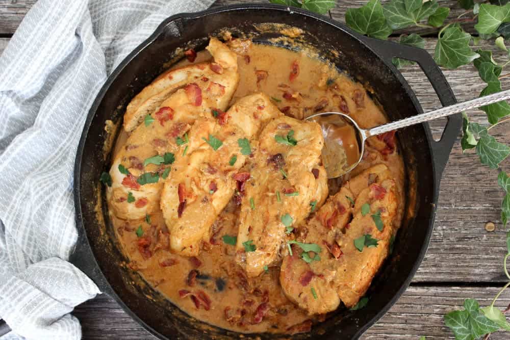 bajon and dijon mustard chicken in a cast iron pot