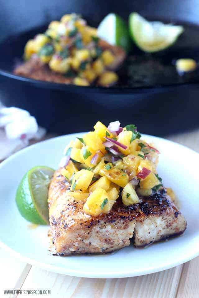 fish topped with pineapple salsa
