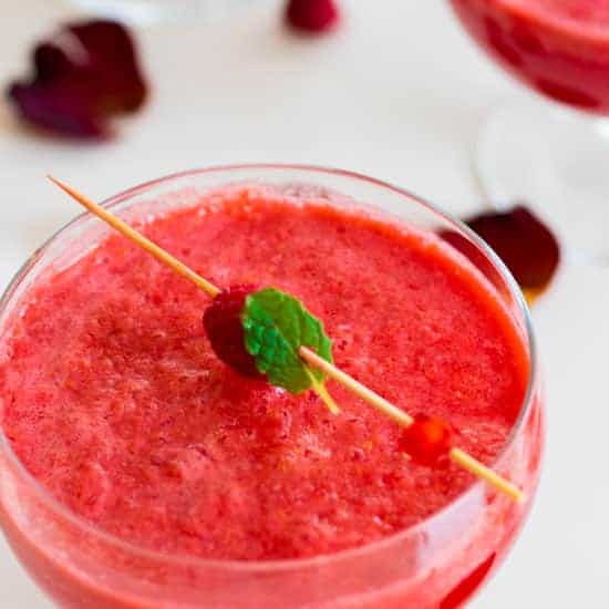 A glass of sparkling raspberry mocktail.