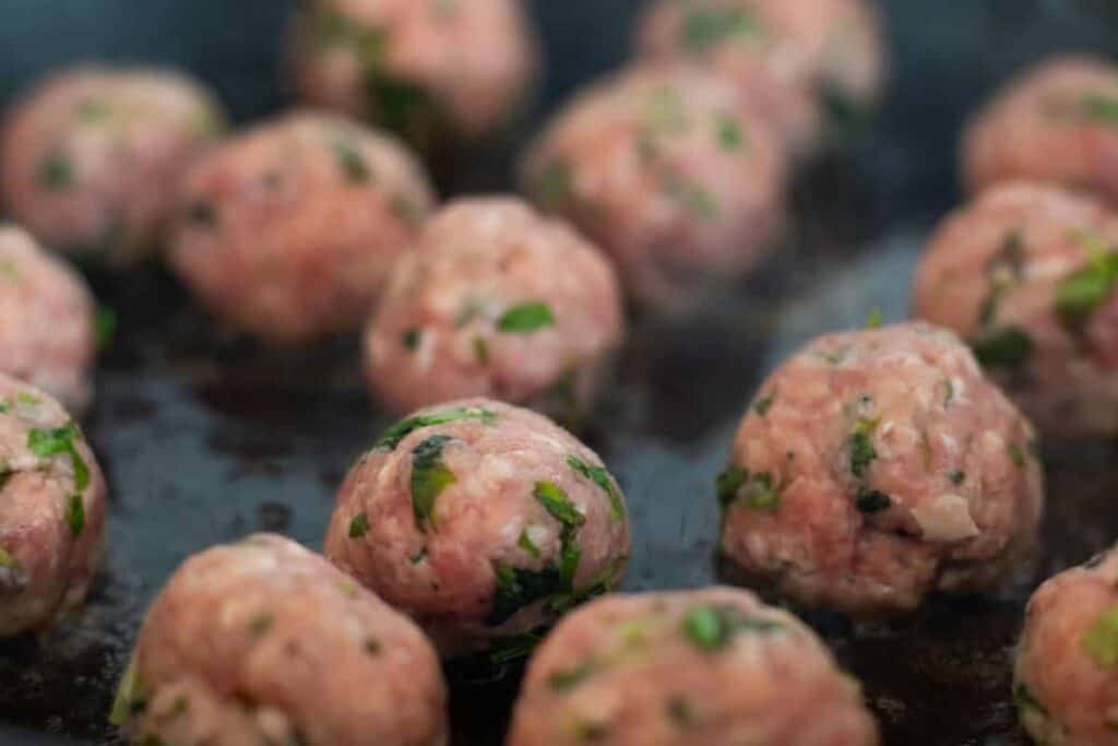 lamb meatballs in a frying pan