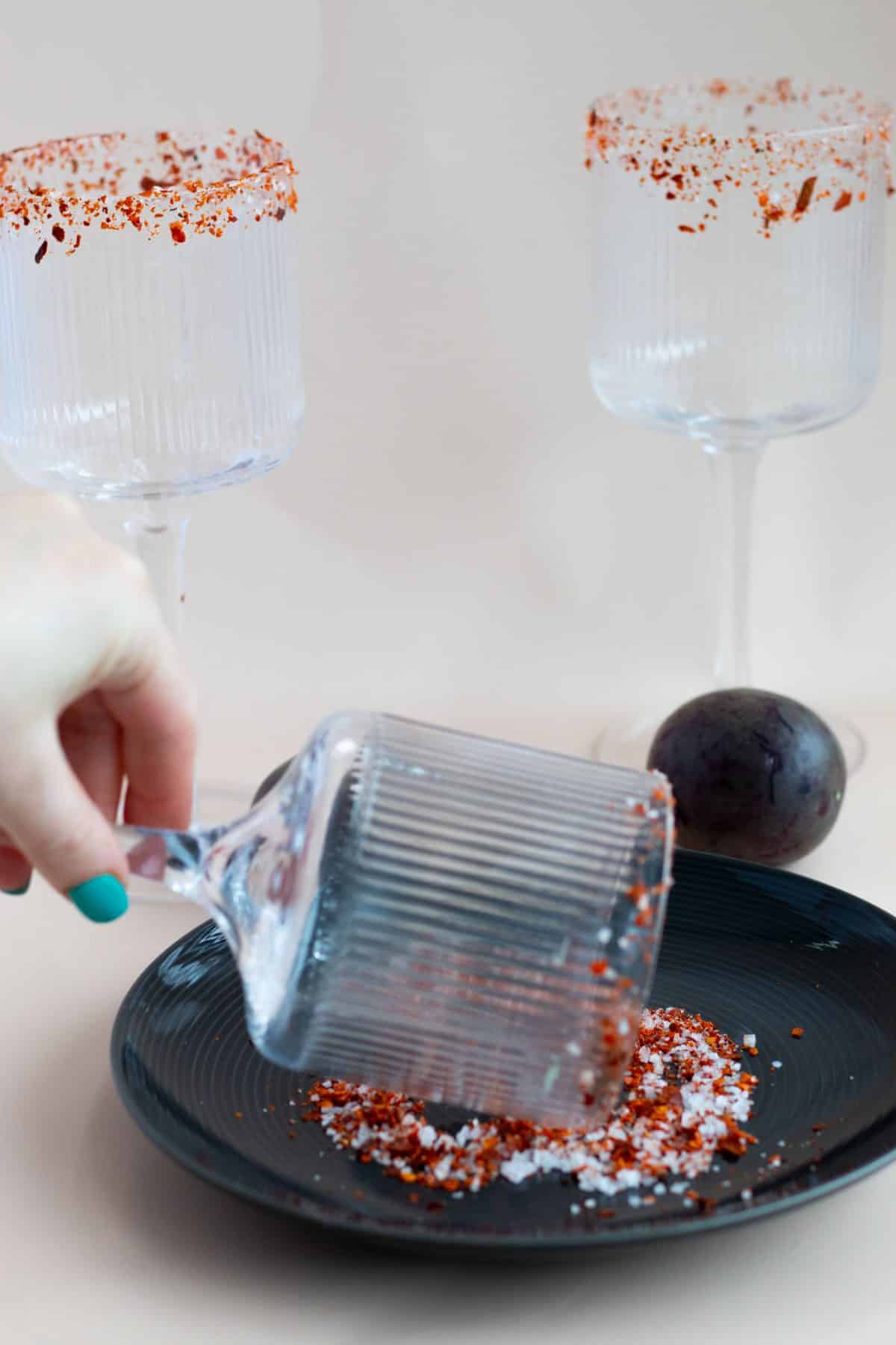 glass being rimmed with sea salt and chili flake mixture