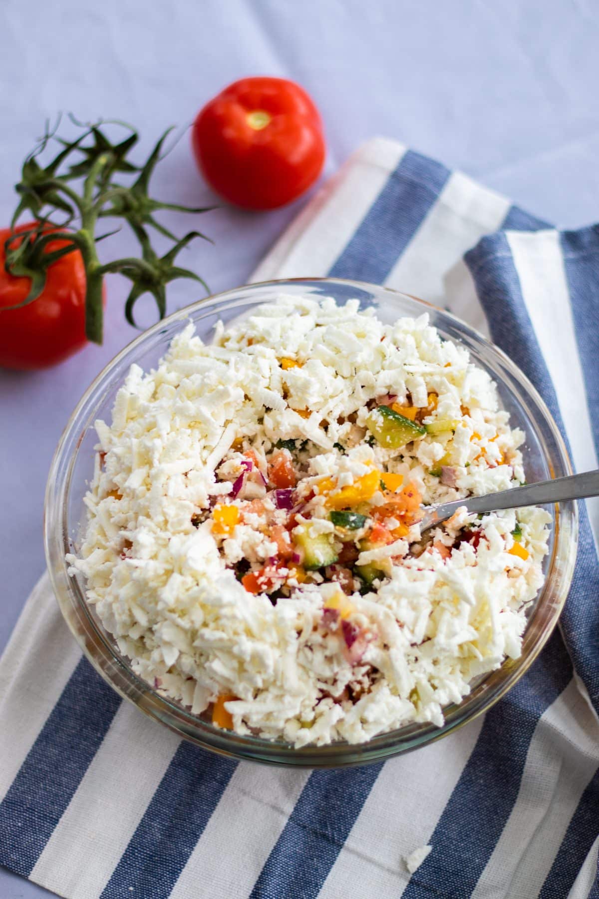 top down view of a shopska salad topped with feta cheese