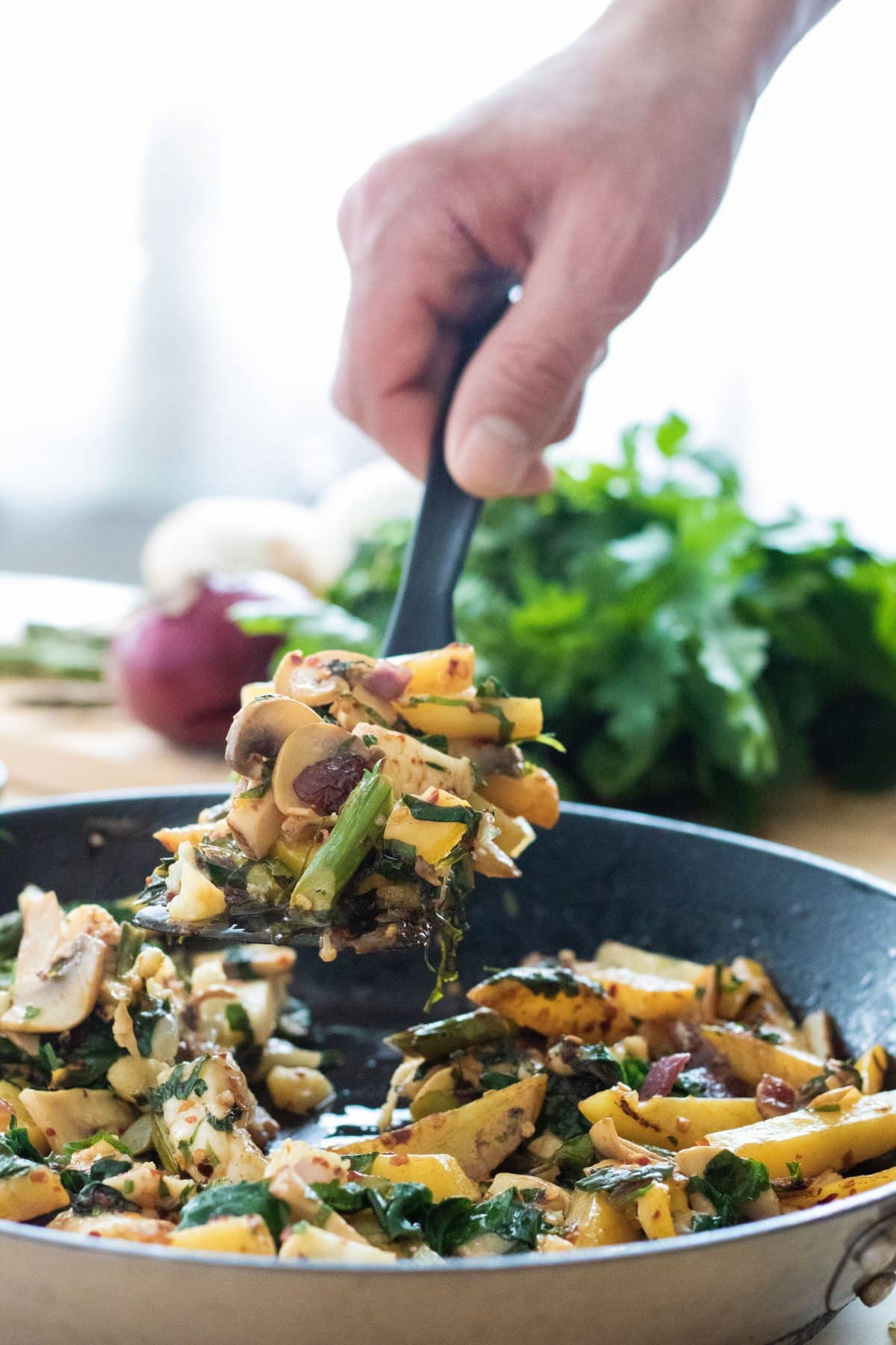 serving potato halloumi stir fry from a pan