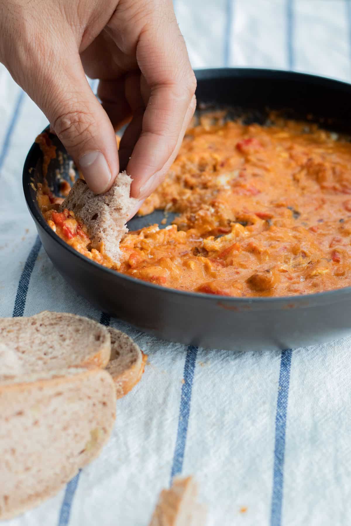 eating shakhuka with bread straight from the pan