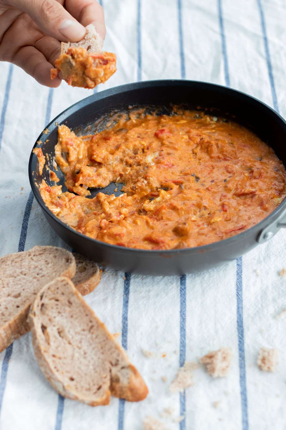 eating shakhuka with bread straight from the pan