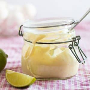 side view of a jar full of lime aioli