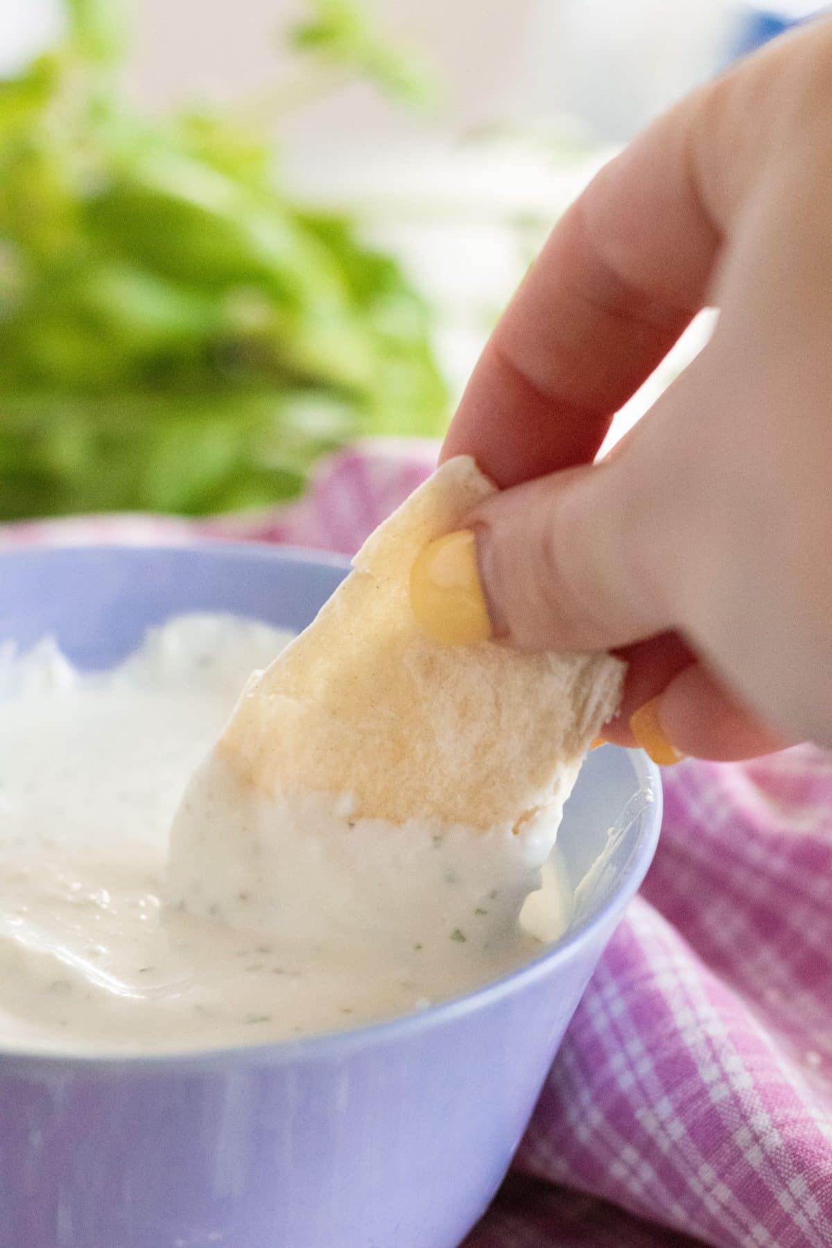 bread being dipped in whipped feta cheese