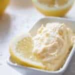 whipped lemon butter with a lemon slice in a white bowl