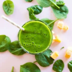 top down view of a green mango spinach smoothie