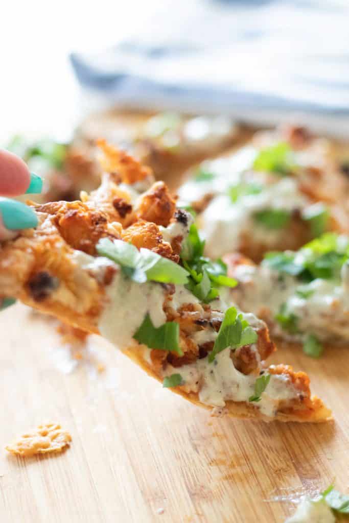 a piece of buffalo cauliflower pizza being picked up