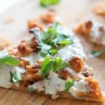 closeup of a slice of puff pastry pizza with buffalo cauliflower and blue cheese sauce