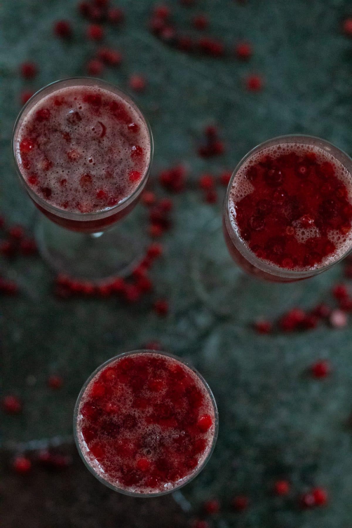 top view of three glasses filled with cranberry ginger ale punch