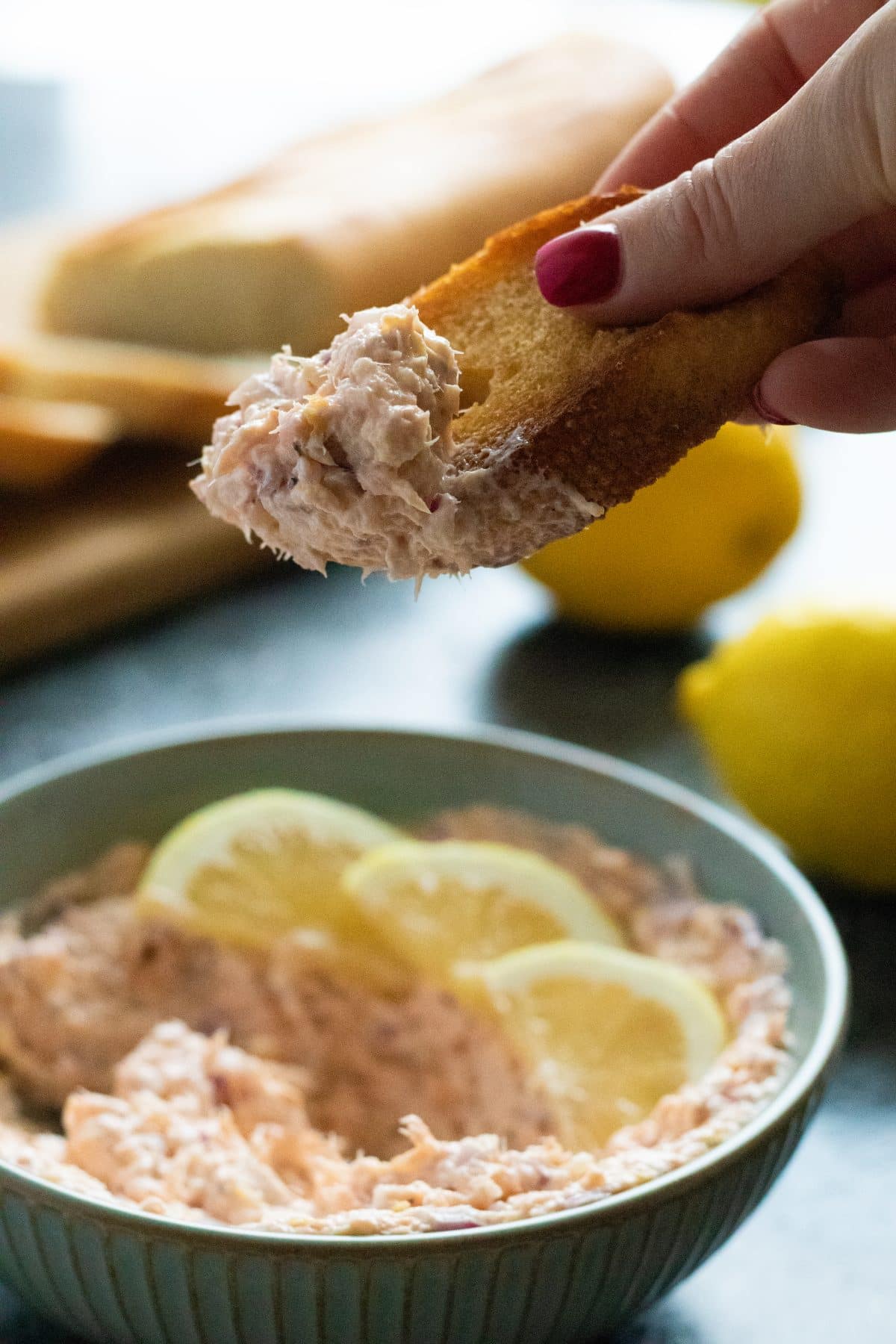 a piece of bread that has been dipped in hot smoked salmon pâté