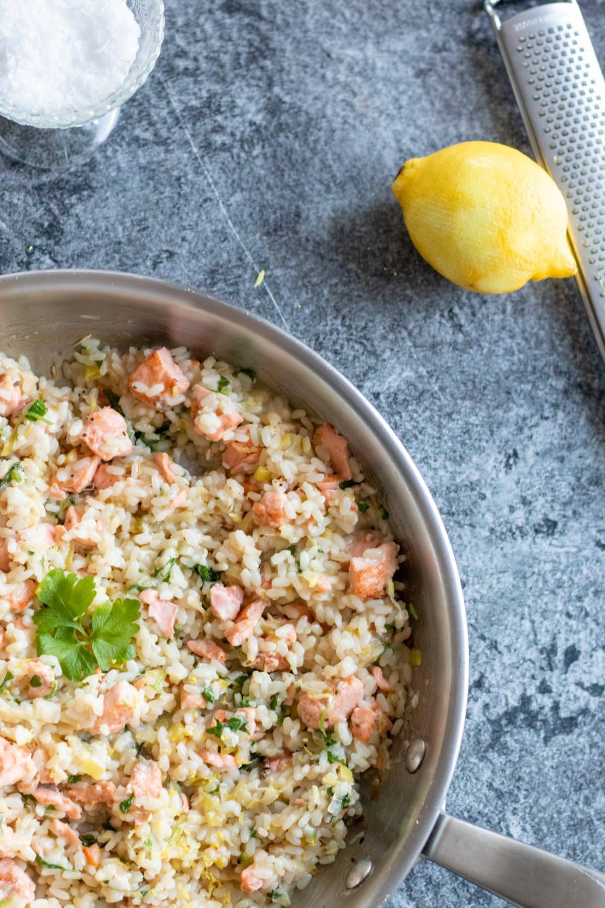 top down view of salmon risotto with lemon.