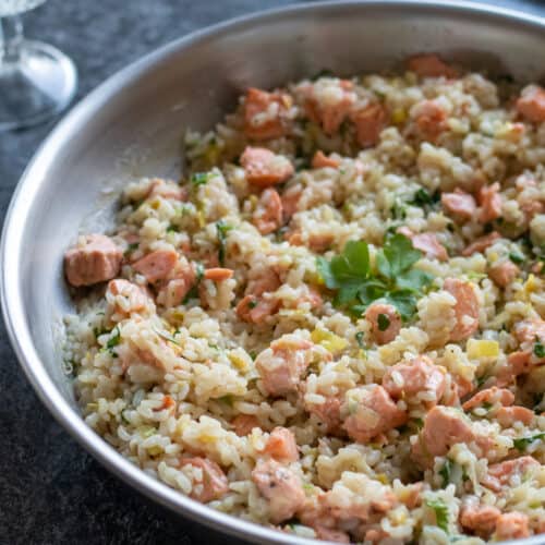 side view of salmon risotto with lemon