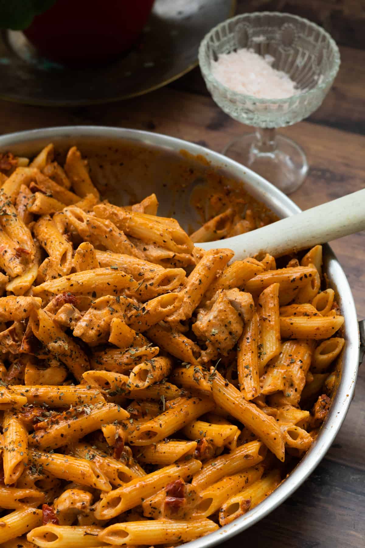 a pan full of creme fraiche pasta topped with dried basil.