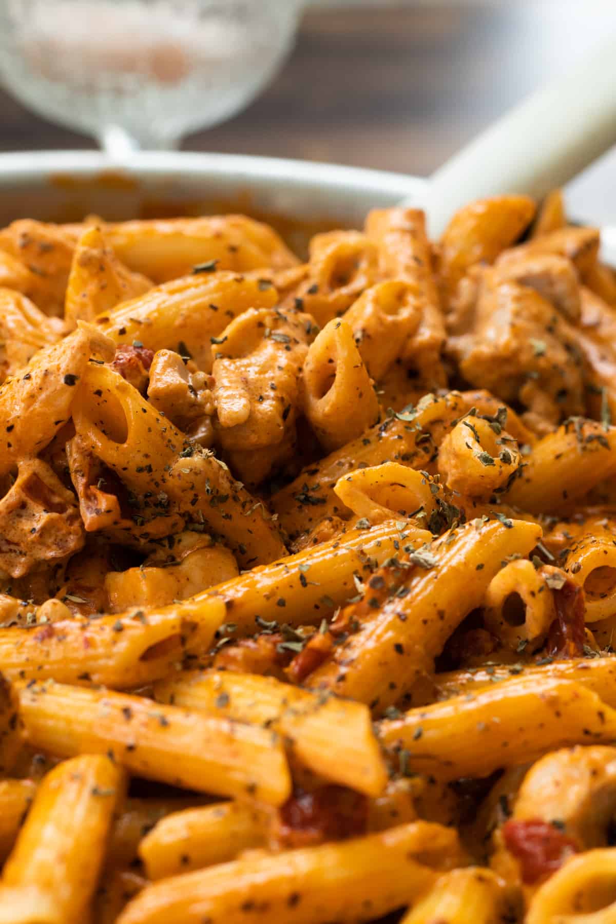 close-up of creme fraiche pasta topped with dried basil