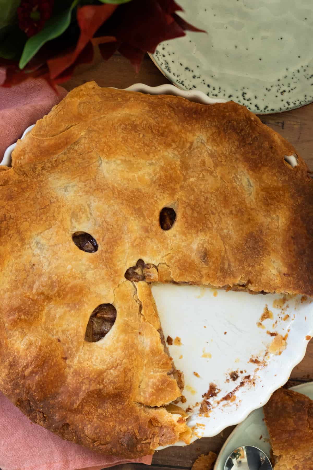 an apple pie with a slice cut out off it