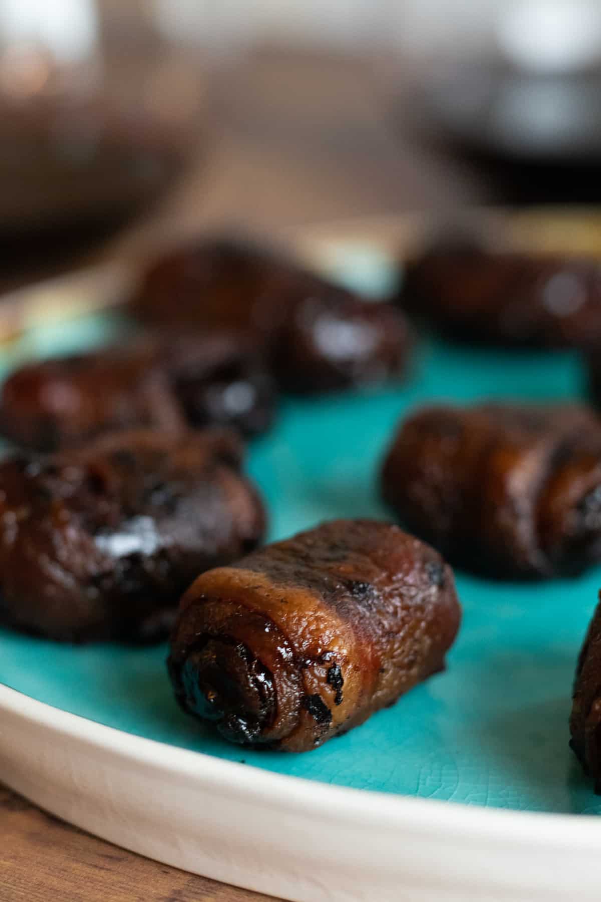 clolse up of bacon wrapped dates