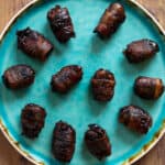 top down view of bacon wrapped dates on a plate
