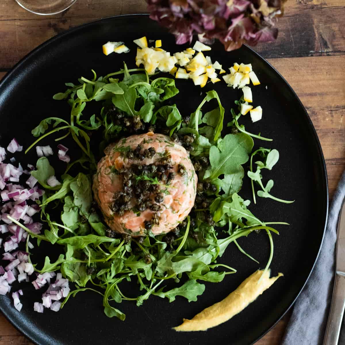 top down view of a deconastructed smoke salmon tartare