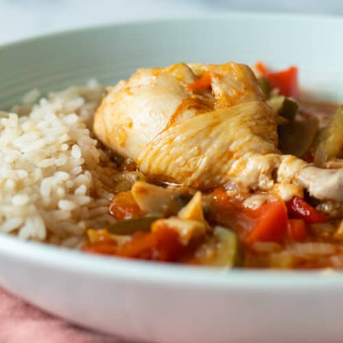close up of chicken stew in blue bowl.