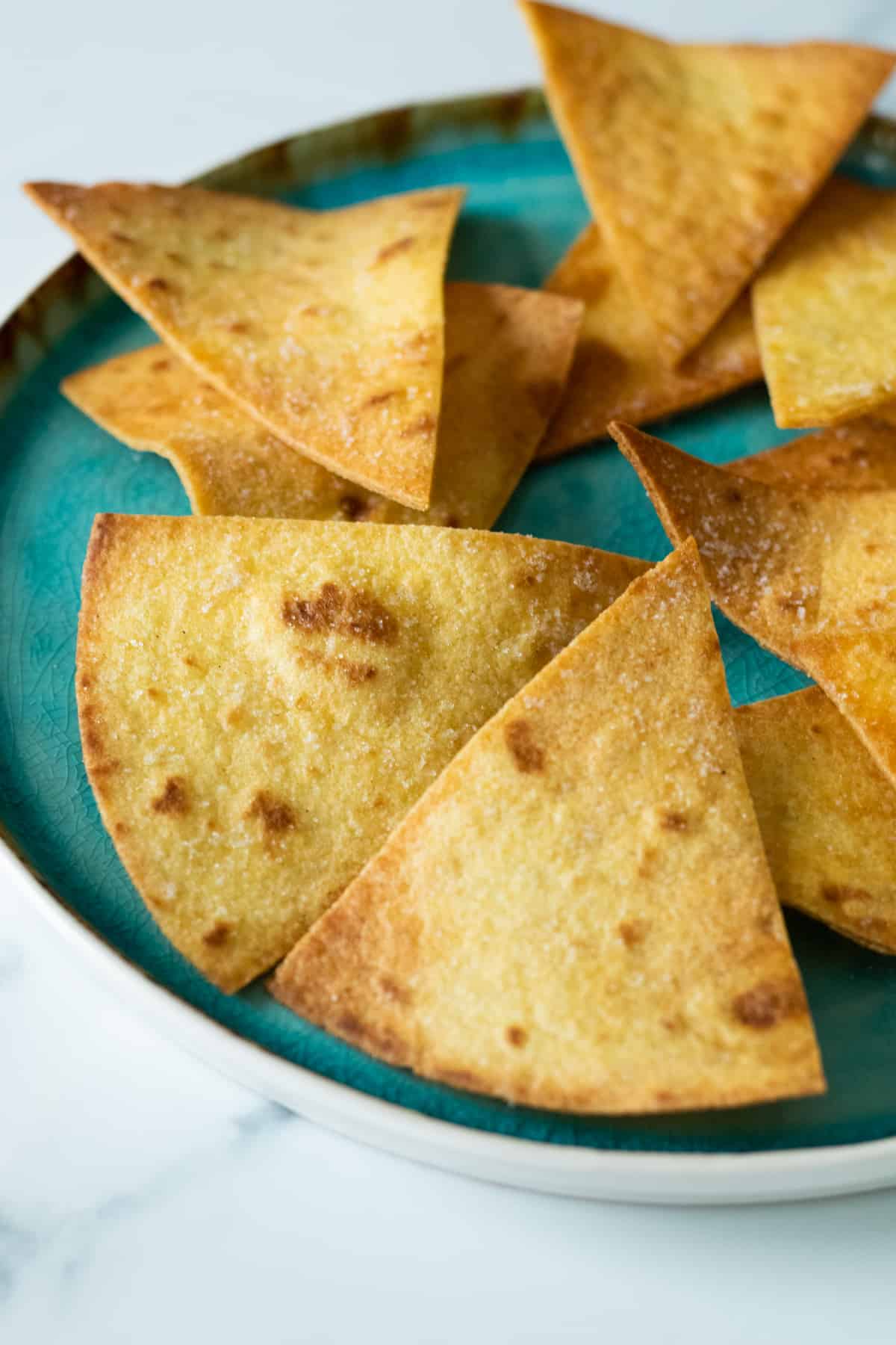 homemade tortilla chips on a blue plate