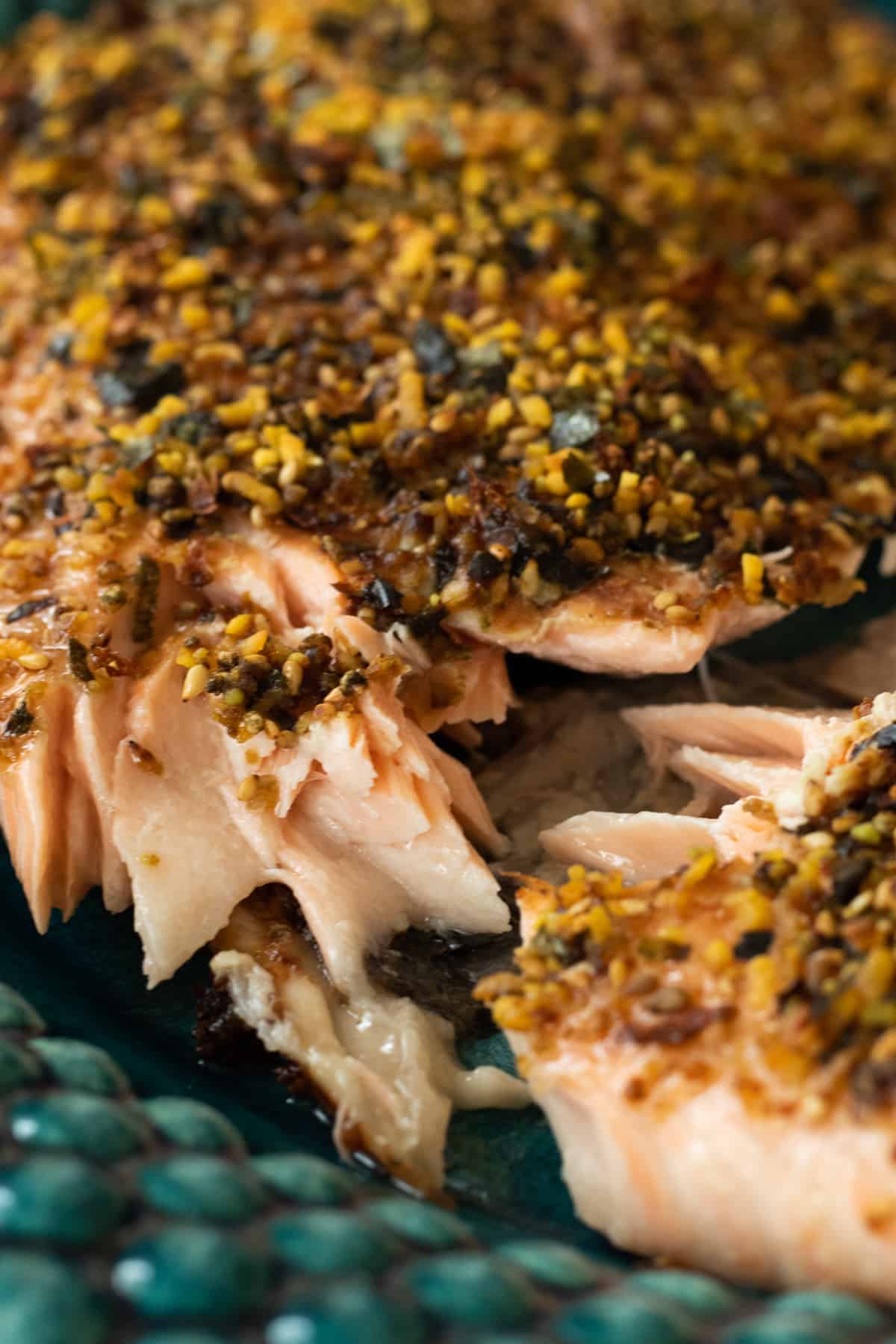 close up of furikake salmon on a blue green plate.