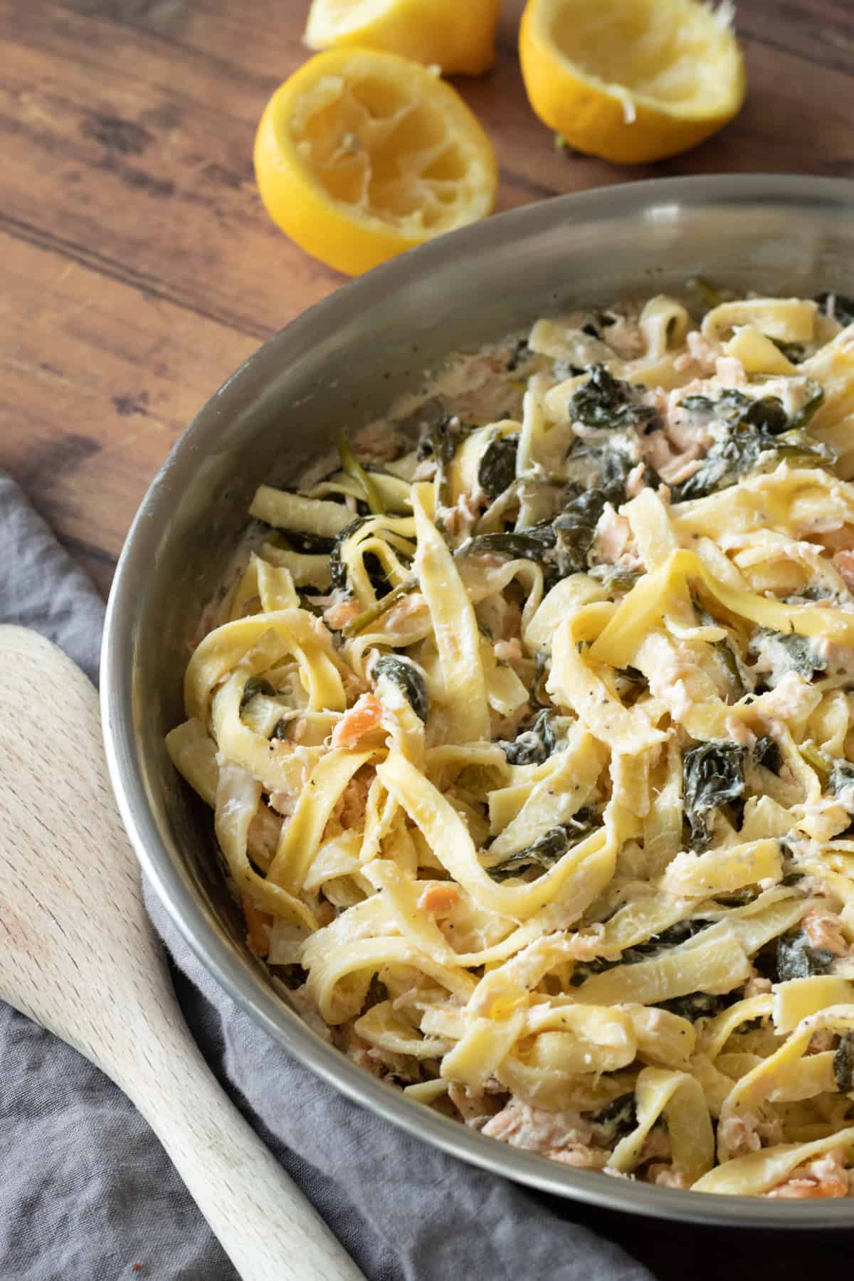 salmon spinach pasta in a pan.