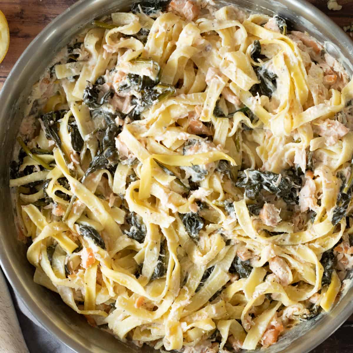 salmon spinach pasta in a pan