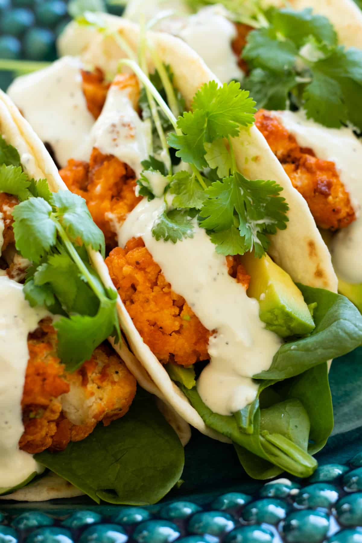 buffalo cauliflower tacos on a blue plate.