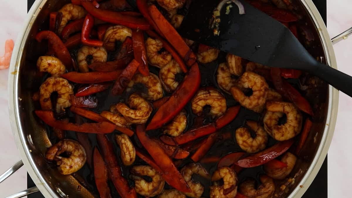 Making shrimp mei fun, here we are simmering shrimp with veggies and sauce.