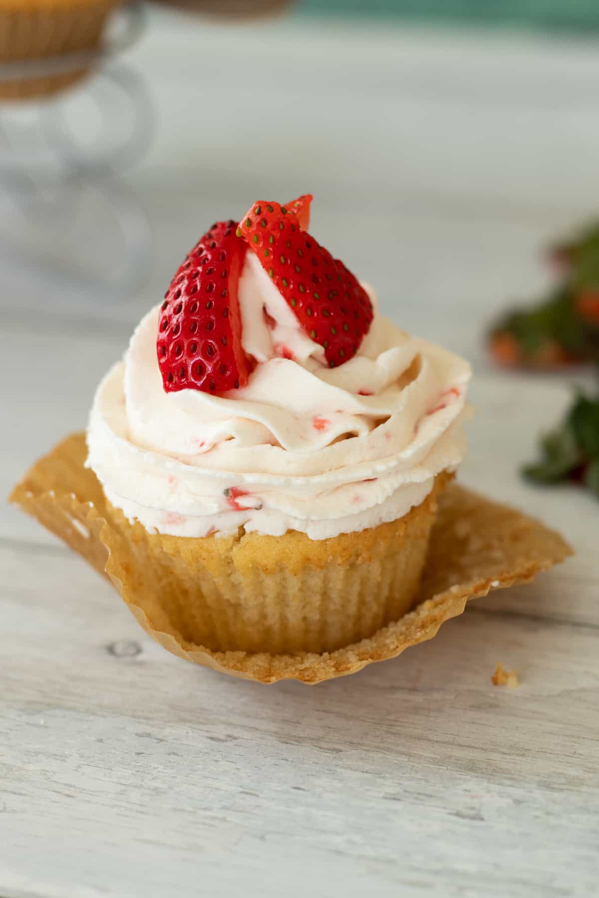 a strawberry filled cupcake topped with strawberries