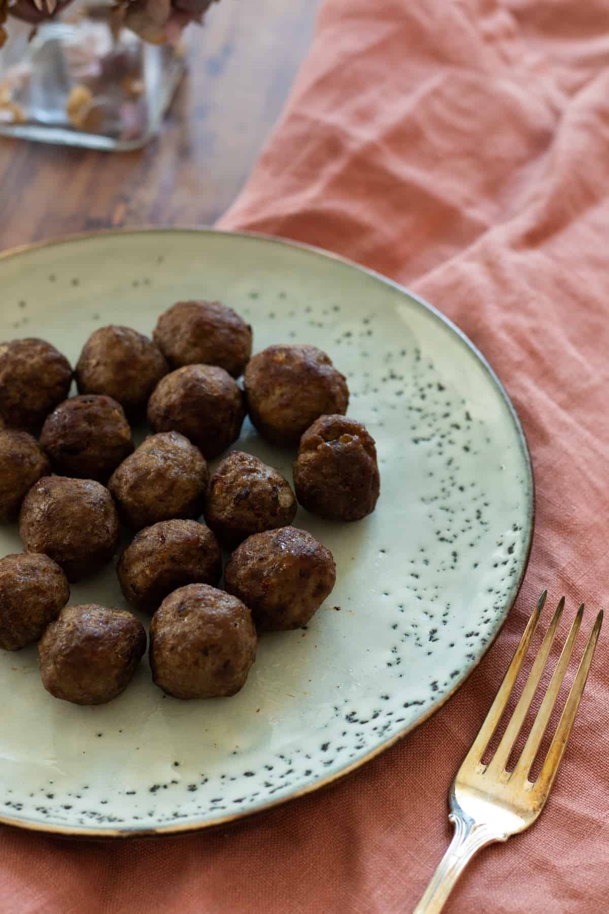 frozen meatballs cooked in air fryer on a blue plate