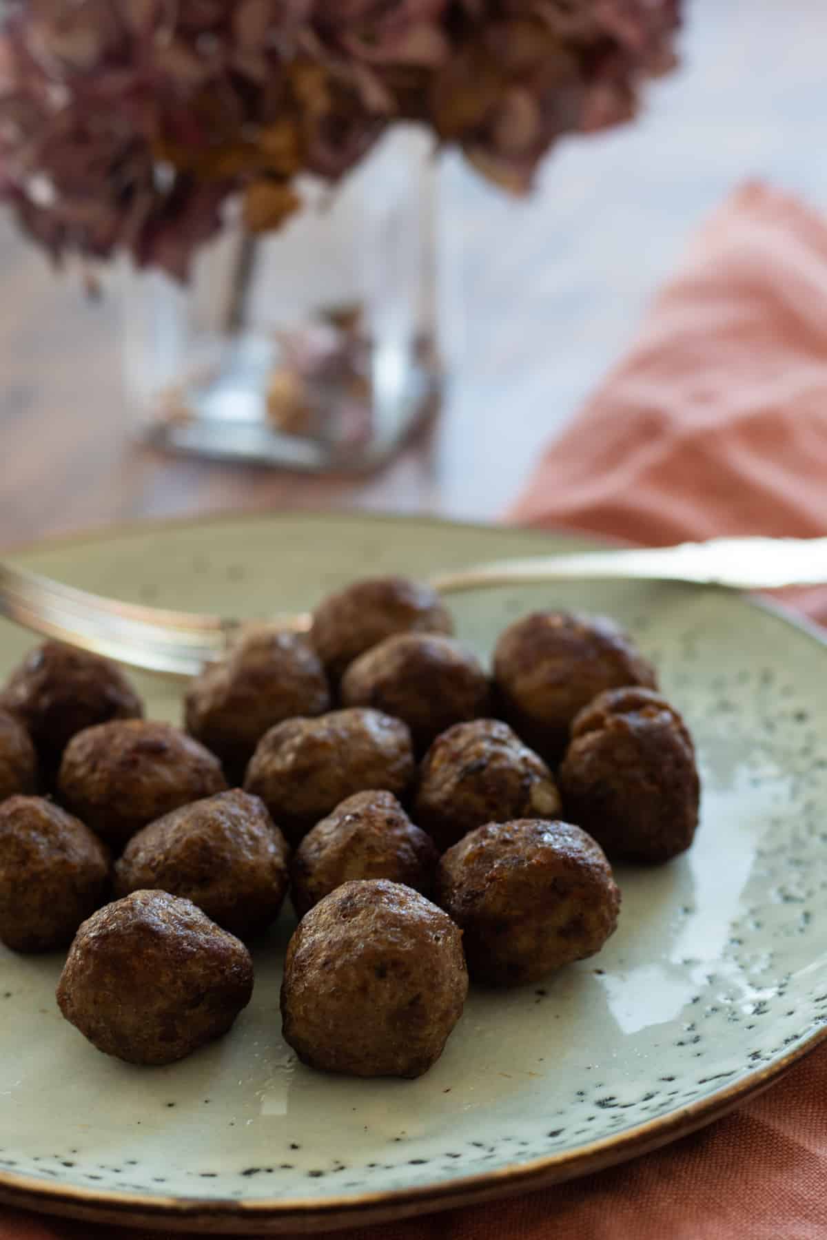 frozen meatballs cooked in air fryer on a blue plate