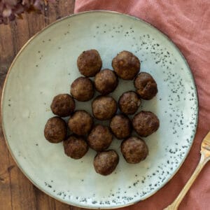 frozen meatballs cooked in air fryer on a blue plate