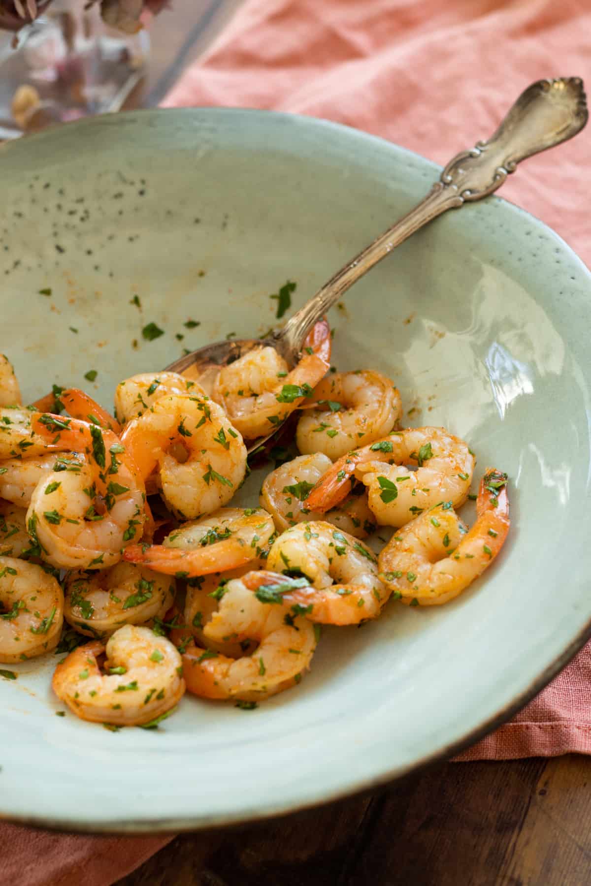 air fryed shrimp with parsley on a blue plate.