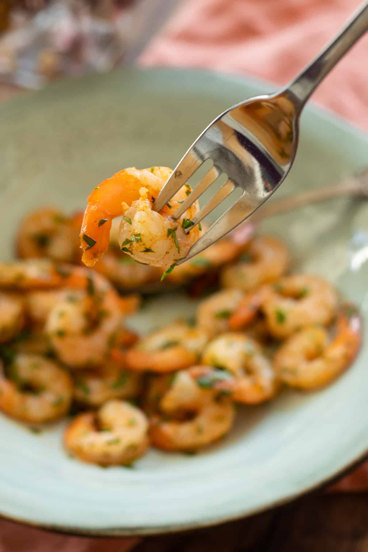 air fryed shrimp with parsley on a blue plate