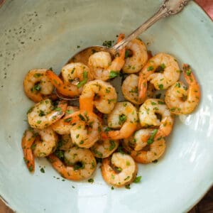 air fryed shrimp with parsley on a blue plate