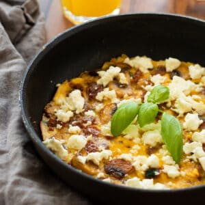 frittata in a pan, topped with basil