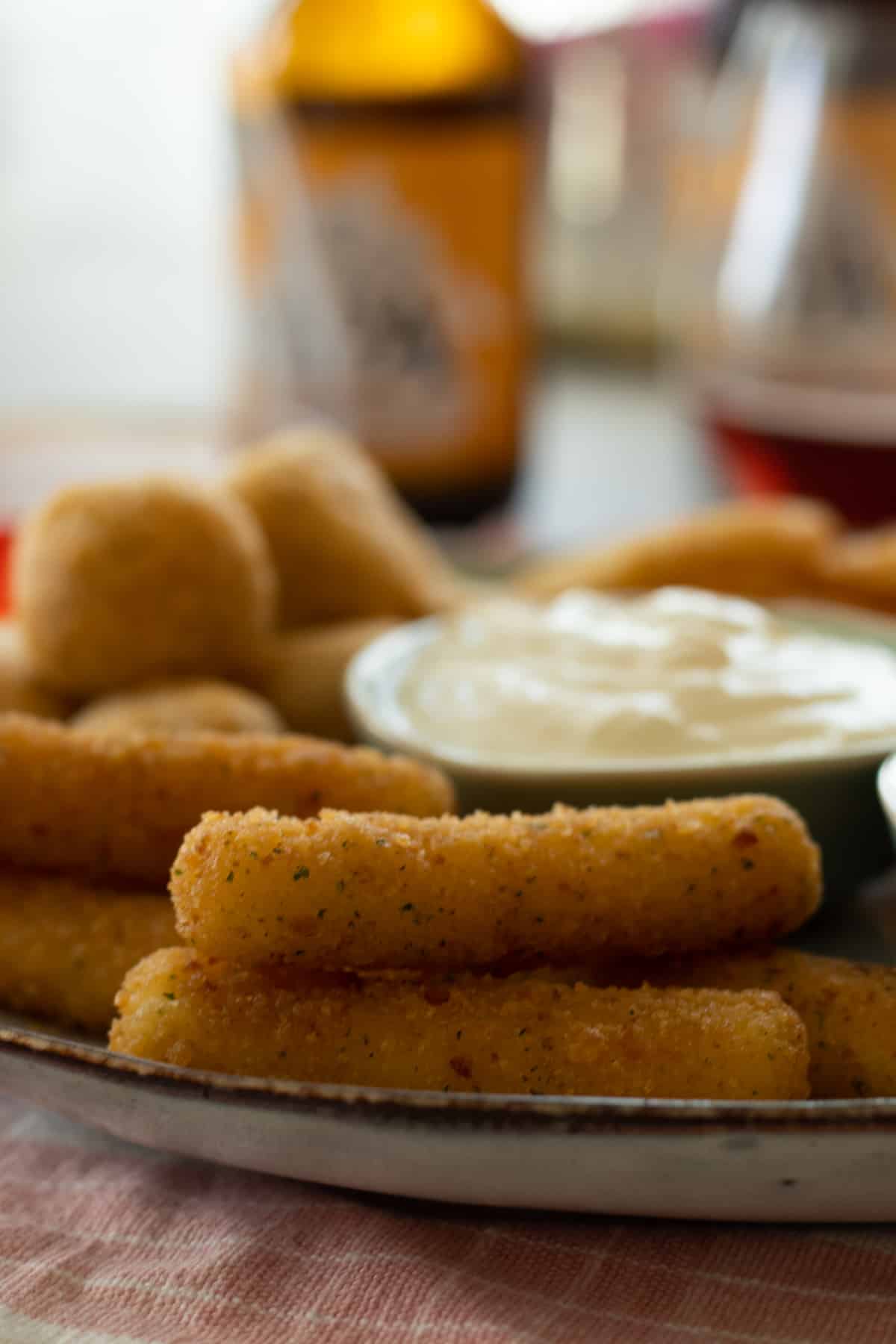 air fried mozzarella sticks on a late with dipping sauces